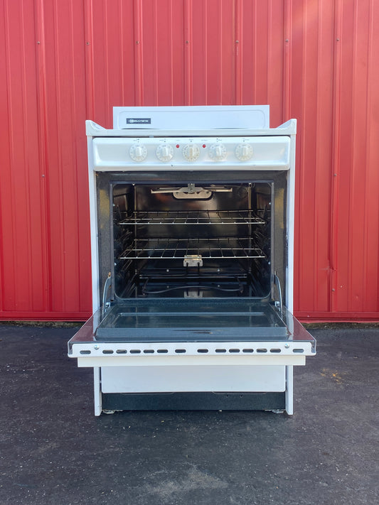 Open oven against a red wall